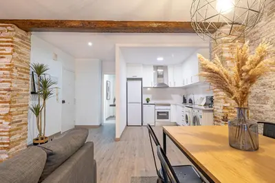 a kitchen and living room with a couch and a table at Apartment in El Mercat in Valencia