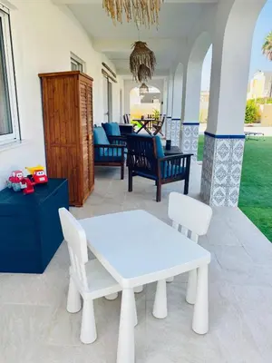 a white table and chairs on a patio at El Riuet-Chalet apartamento a 1 minuto de la playa, Cullera in Cullera