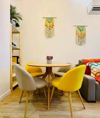 a dining room with a table and yellow chairs at Color & Design next to Russafa SOHO in Valencia