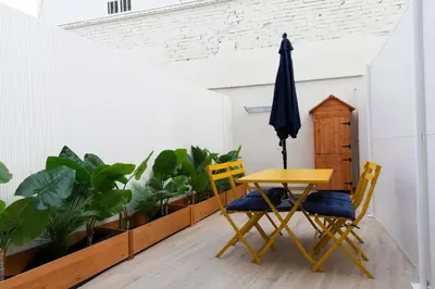 a dining room with a table and chairs and plants at Color & Design next to Russafa SOHO in Valencia
