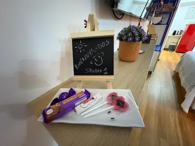 a table with a plate of food and a sign at Studio 1 Port Valencia in Valencia