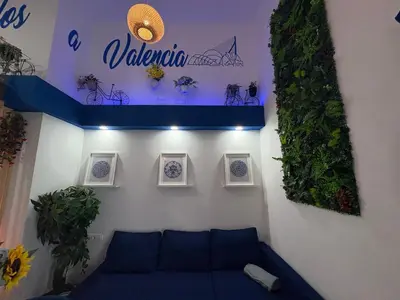 a blue couch in a room with pictures on the wall at Studio 1 Port Valencia in Valencia