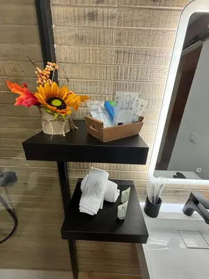 a bathroom with a table with a vase of flowers at Studio 2 Port Valencia in Valencia