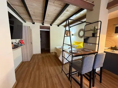 a room with a desk and a room with a kitchen at Studio 2 Port Valencia in Valencia