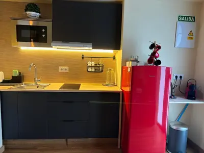 a kitchen with a red refrigerator and a sink at Studio 2 Port Valencia in Valencia