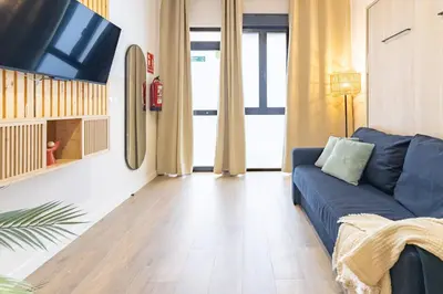 a shelf with towels and a plant in a room at Travel Habitat Mediterranean Lofts in Valencia