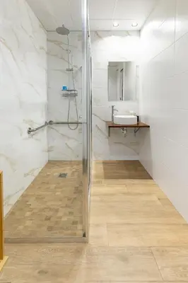 a kitchen with white cabinets and a dining table at Travel Habitat Mediterranean Lofts in Valencia