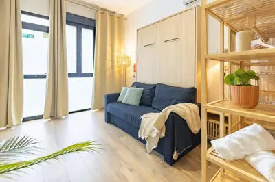 a bathroom with a toilet and a glass shower at Travel Habitat Mediterranean Lofts in Valencia