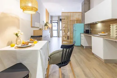 two plates of food on a table with orange juice at Travel Habitat Mediterranean Lofts in Valencia