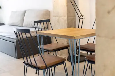 a table and chairs in a room with a couch at NEW BEACH Flats valencia 1 in Valencia
