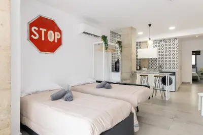 a stop sign above three beds in a room at NEW Beach Flats Valencia 3 in Valencia