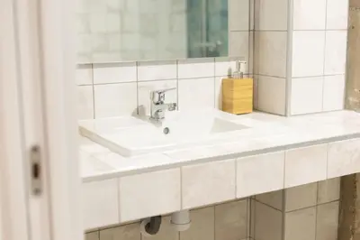 a bathroom with a white sink and a mirror at NEW Beach Flats Valencia 3 in Valencia