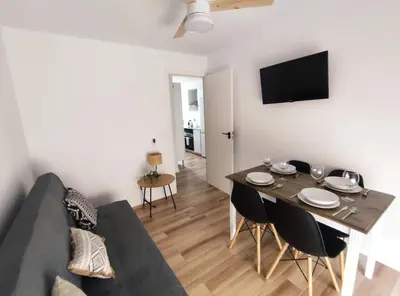 a living room with a couch and a table with chairs at Apartamento 3 Habitaciones 2 Baños in Puerto de Sagunto