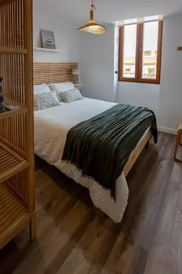 a bedroom with a large bed with a wooden headboard at Tenerias Apart Corp , 4 Piso in Valencia