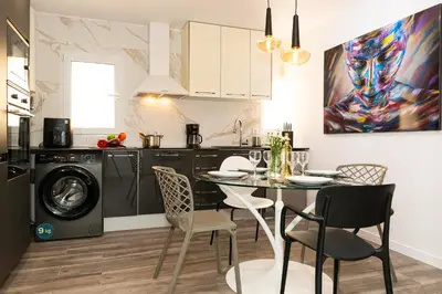 a kitchen and dining room with a table and chairs at SingularStays Padre Urbano in Valencia