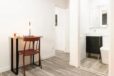 a bathroom with a table and a sink and a toilet at SingularStays Padre Urbano in Valencia