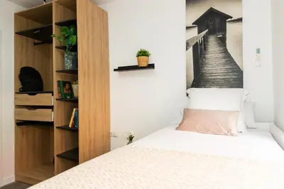 a bedroom with a bed and a book shelf at SingularStays Padre Urbano in Valencia