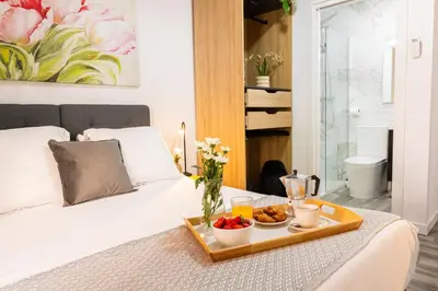 a tray of food on a bed in a bedroom at SingularStays Padre Urbano in Valencia