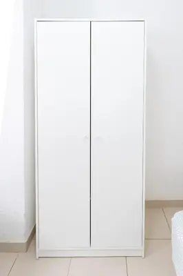 two white wardrobes in a bedroom with white walls at Habitación Maritim 1 in Valencia