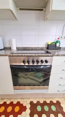 a kitchen with an oven with a tile floor at Habitación Maritim 2 in Valencia