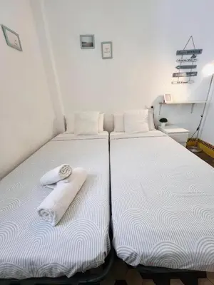 two beds sitting next to each other in a room at Habitación Maritim 2 in Valencia