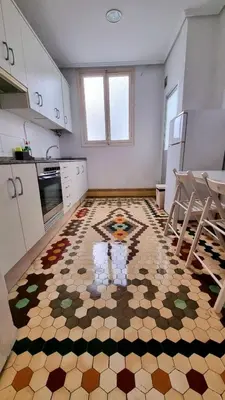 a kitchen with a tile floor with a design on it at Habitación Maritim 2 in Valencia