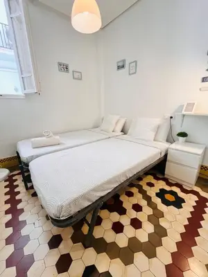 a large bed in a room with a rug at Habitación Maritim 2 in Valencia