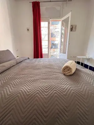 a bedroom with a large bed with a hat on it at Habitacion Maritim 3 in Valencia