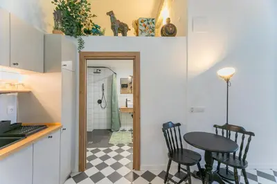 a kitchen with a table and chairs in a room at Cozy loft Jubeco in Valencia