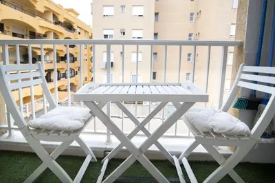 a white table and two chairs on a balcony at Piso Reformado Cerca de la Playa y de Valencia Ciudad en el Barrio de San Antonio in Cullera
