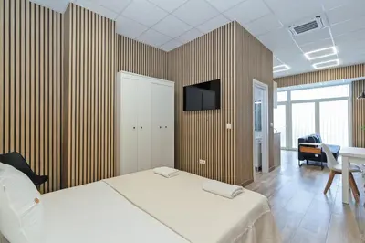 a bedroom with a bed and a tv on a wall at GuestReady - Quaint Stay in Valencia in Valencia