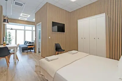 a bedroom with a bed and a desk and a tv at GuestReady - Quaint Stay in Valencia in Valencia
