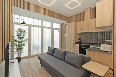 a living room with a couch and a kitchen at GuestReady - Quaint Stay in Valencia in Valencia