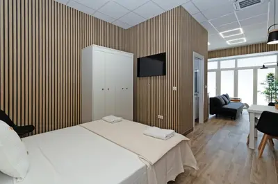 a bedroom with a bed and a tv on a wall at GuestReady - Delightful Valencian Stay in Valencia