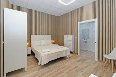 a bedroom with a large bed and a bathroom at GuestReady - Delightful Valencian Stay in Valencia