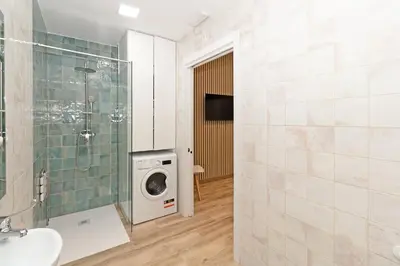 a bathroom with a washing machine and a washer and dryer at GuestReady - Delightful Valencian Stay in Valencia