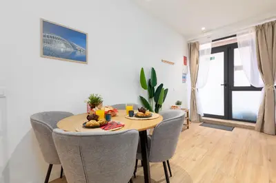 a dining room with a wooden table and chairs at Travel Habitat Marítim-Serrería Lofts in Valencia