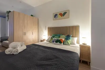 a bedroom with a large bed with towels on it at Travel Habitat Marítim-Serrería Lofts in Valencia