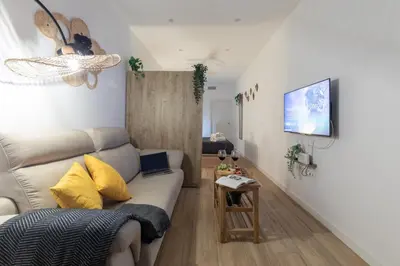 a living room with a couch and a table at Travel Habitat Marítim-Serrería Lofts in Valencia