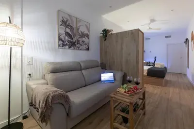 a living room with a couch and a table at Travel Habitat Marítim-Serrería Lofts in Valencia