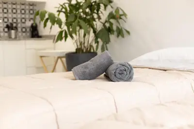 a bed with two towels on top of it at NEW BEACH Flats Valencia 2 in Valencia