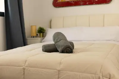 a stuffed animal is sitting on a bed at NEW BEACH Flats Valencia 2 in Valencia