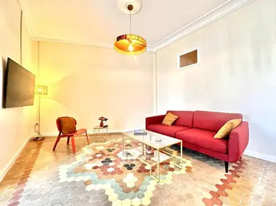 a living room with a red couch and a glass table at Stylish Ruzafa Market in Valencia