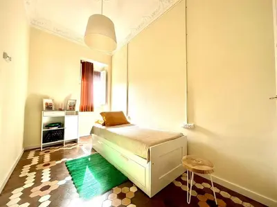 a small bedroom with a bed in a room at Stylish Ruzafa Market in Valencia