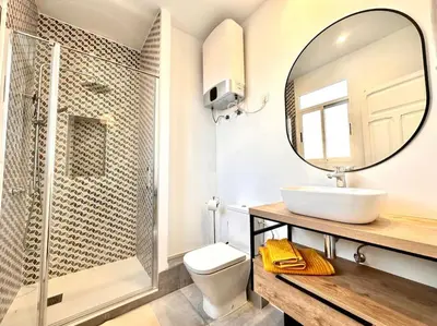 a bathroom with a sink and a mirror at Stylish Ruzafa Market in Valencia