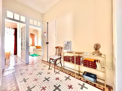 a living room with a table and a chair at Stylish Ruzafa Market in Valencia