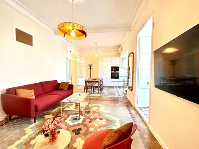 a living room with a red couch and a table at Stylish Ruzafa Market in Valencia