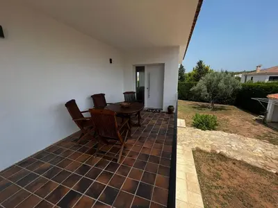 two images of a patio with a table and chairs at Acogedora casa con piscina in Lliria