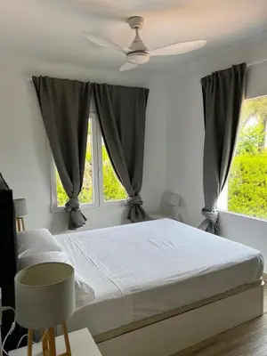 a bedroom with a bed and two windows at Acogedora casa con piscina in Lliria