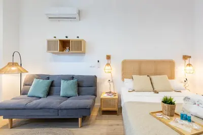 a living room with a bed and a blue couch at Travel Habitat Ruzafa Lofts in Valencia